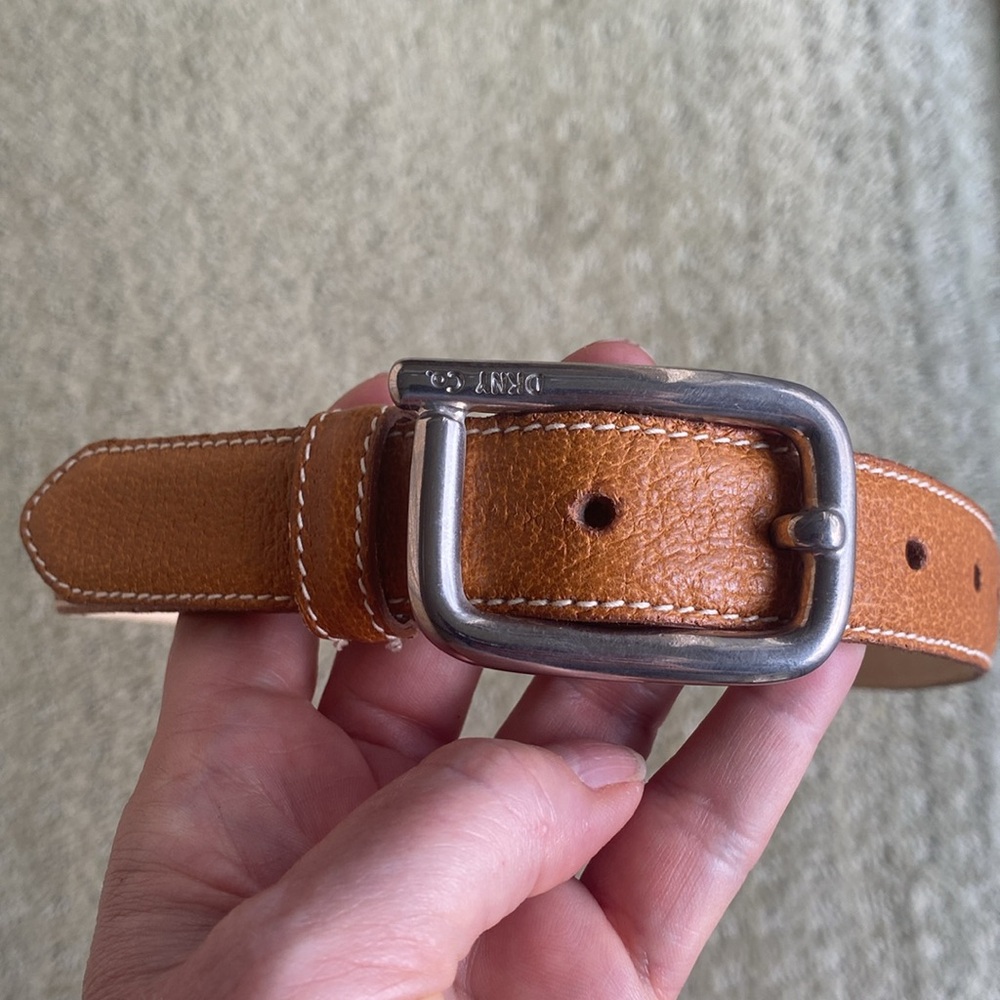 Tan leather belt with sliver buckle,excellent condition. Top to middle hole 32”.